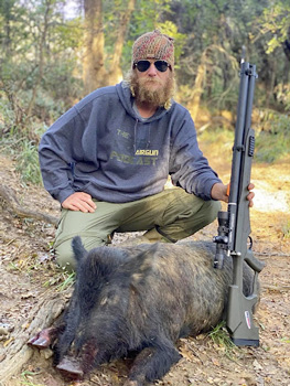 Texas Outdoorsman, Chris Cook, with his wild pig and the original AirSaber
