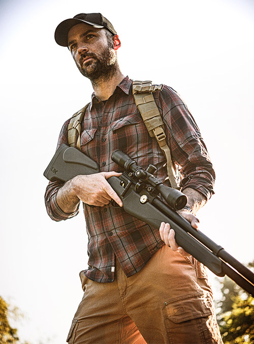 Man carrying the Umarex Origin with backpack on